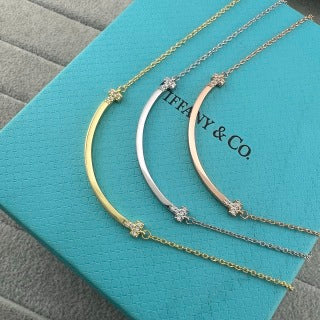 Tiffany necklace with side-set diamonds and a "Smile" pendant.