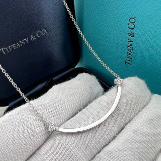 Tiffany necklace with side-set diamonds and a "Smile" pendant.