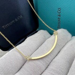 Tiffany necklace with side-set diamonds and a "Smile" pendant.