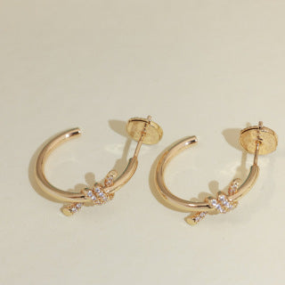 Tiffany Knot Stud Earrings – Polished Finish with Half-Pavé Diamonds